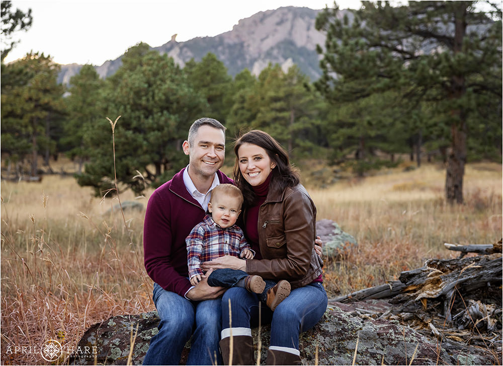 A small family with a cute baby boy wearing plaid at their Boulder Colorado family photography session at Shanahan Ridge Trail