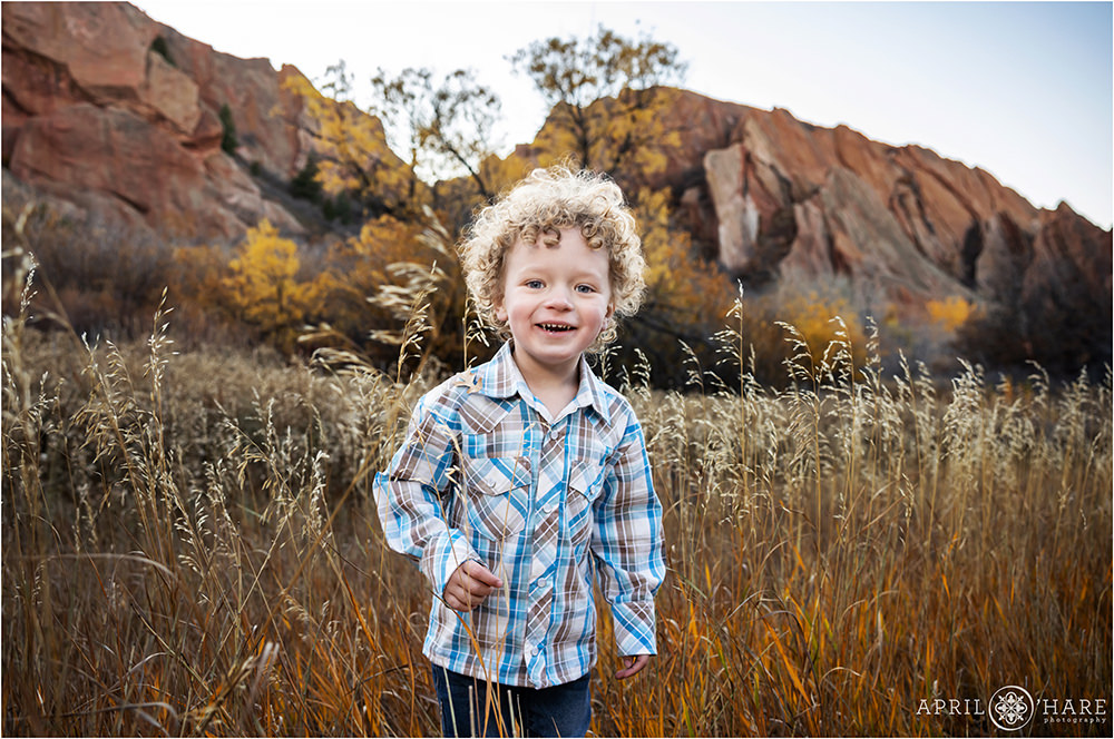 Pretty Fall Backdrop with dramatic red rock formations for a sweet little boy with curly hair