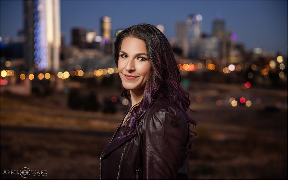 Cute sassy professional headshot portrait with glowing Denver skyline in the backdrop