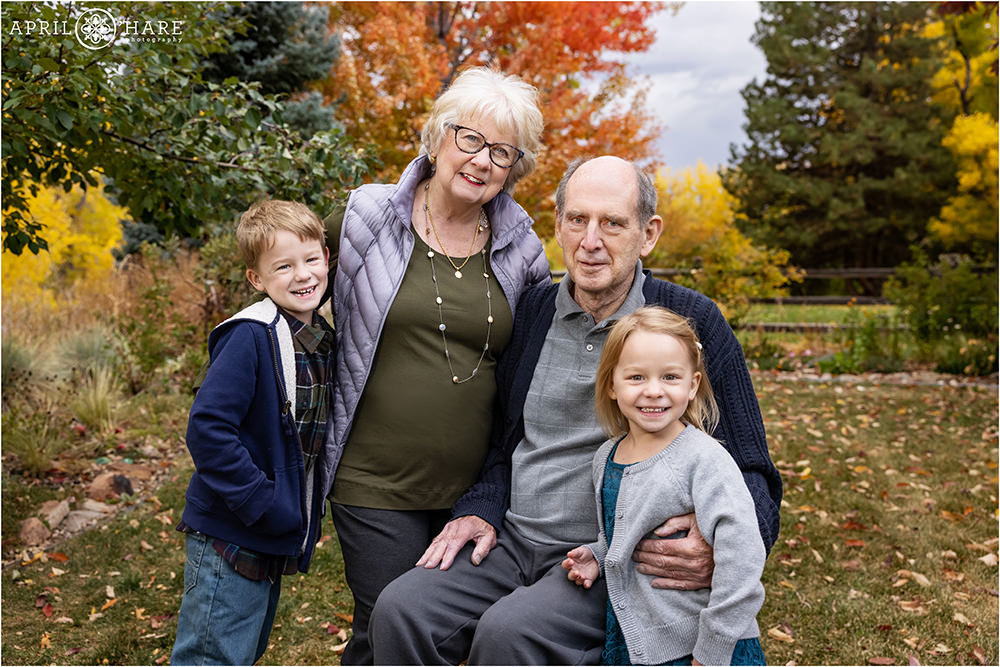 Grandparents with their grandkids in the backyard in Denver during autumn color