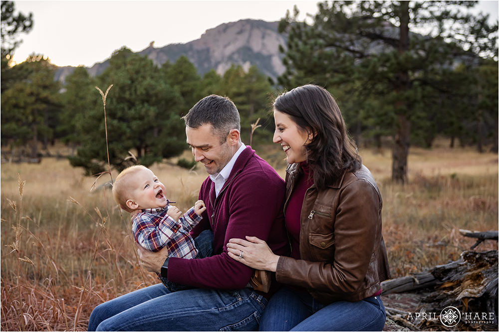 Sweet photo of a baby boy laughing with his parents at their family photography session at Shanahan Ridge Trailhead in Boulder