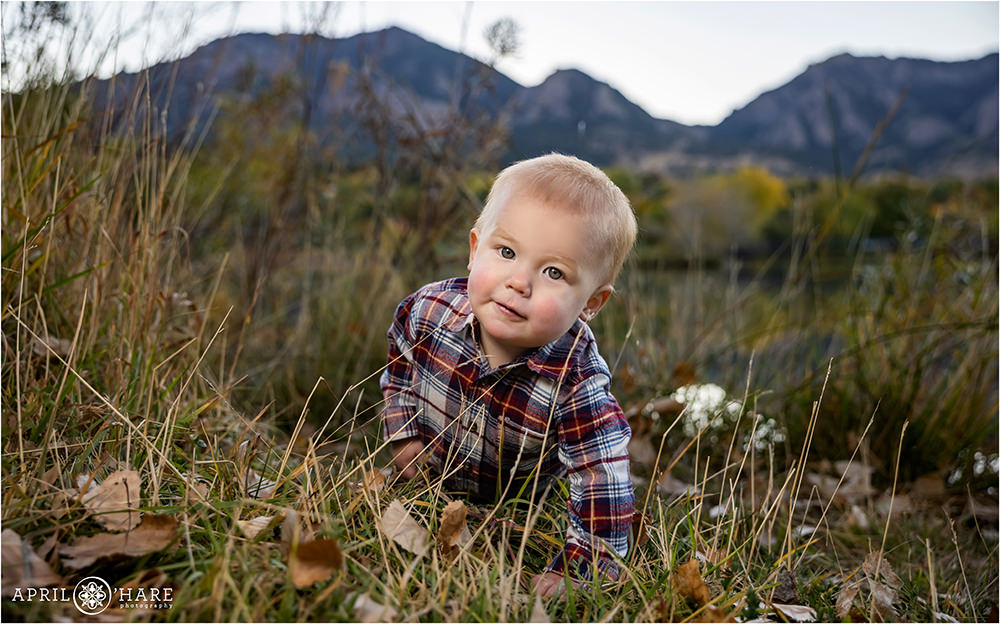 Adorable baby boy wearing a plaid long sleeved shirt at his family photoshoot at Viele Lake in Boulder Colorado