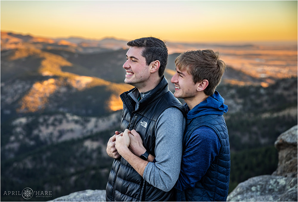 Sweet moment of a couple looking out at the beautiful sunrise mountain view at Lost Gulch in Boulder