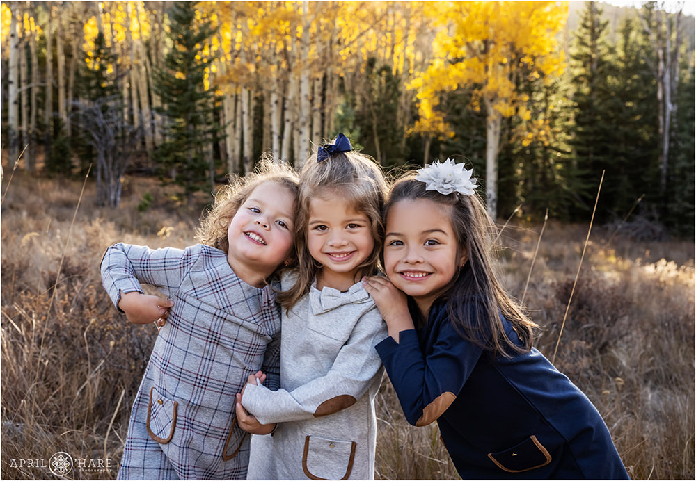Cute photo of 3 sisters in a fall color mountain meadow in Evergreen Colorado