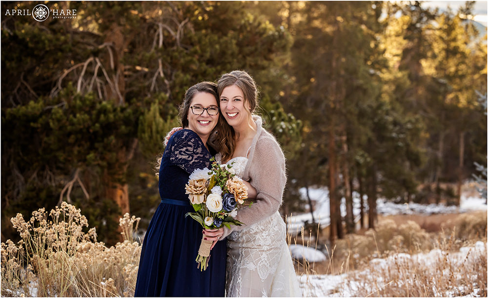 Bride hugs her sister on her winter wedding day in Keystone Colorado
