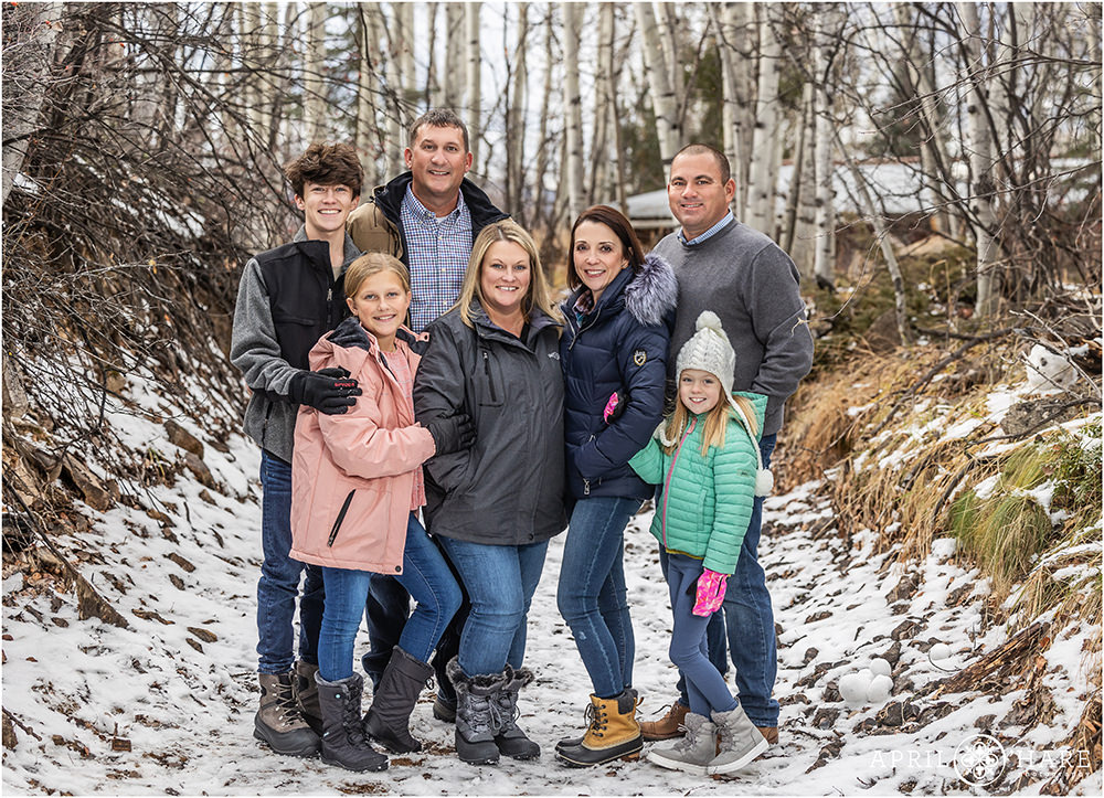 Extended family portrait in a snowy woodsy area in Aspen Colorado