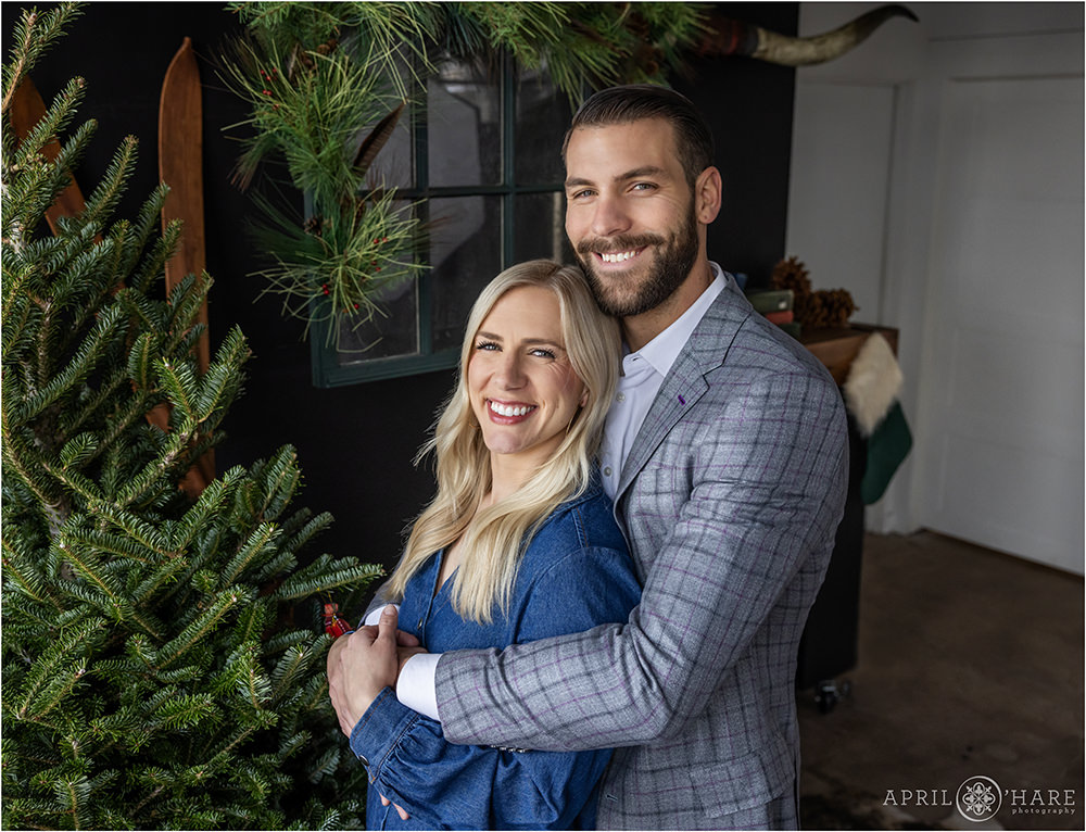 Christmas Portrait for a Good Looking Couple with Natural Light at an Indoor Styled Holiday Set