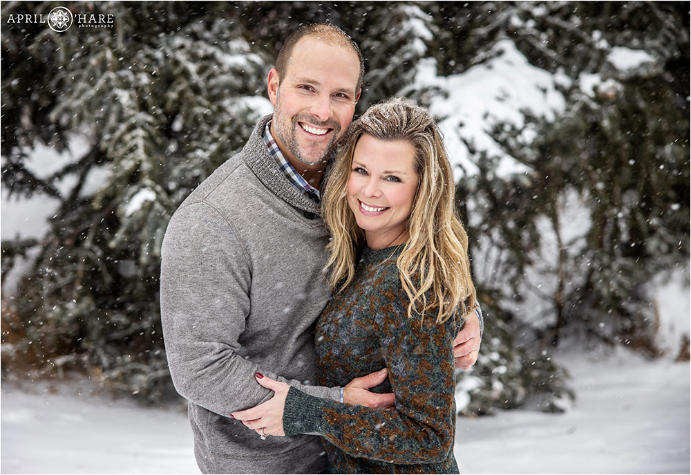 Cute couple pose for a photo in their sweaters on a snowy winter day in Beaver Creek Colorado