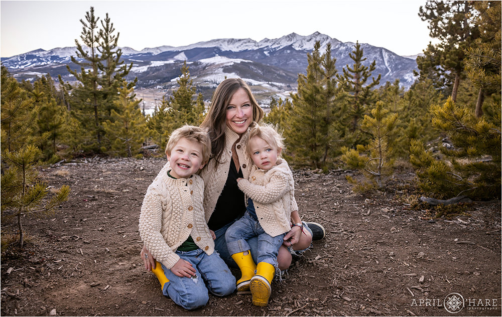 A mom holds her two sons with the mountain view backdrop at Sapphire Point in Colorado