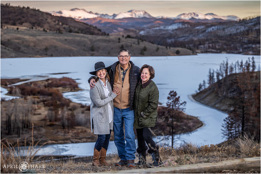 Adult daughter poses for a photo with her parents at the C Lazy U Ranch in Colorado
