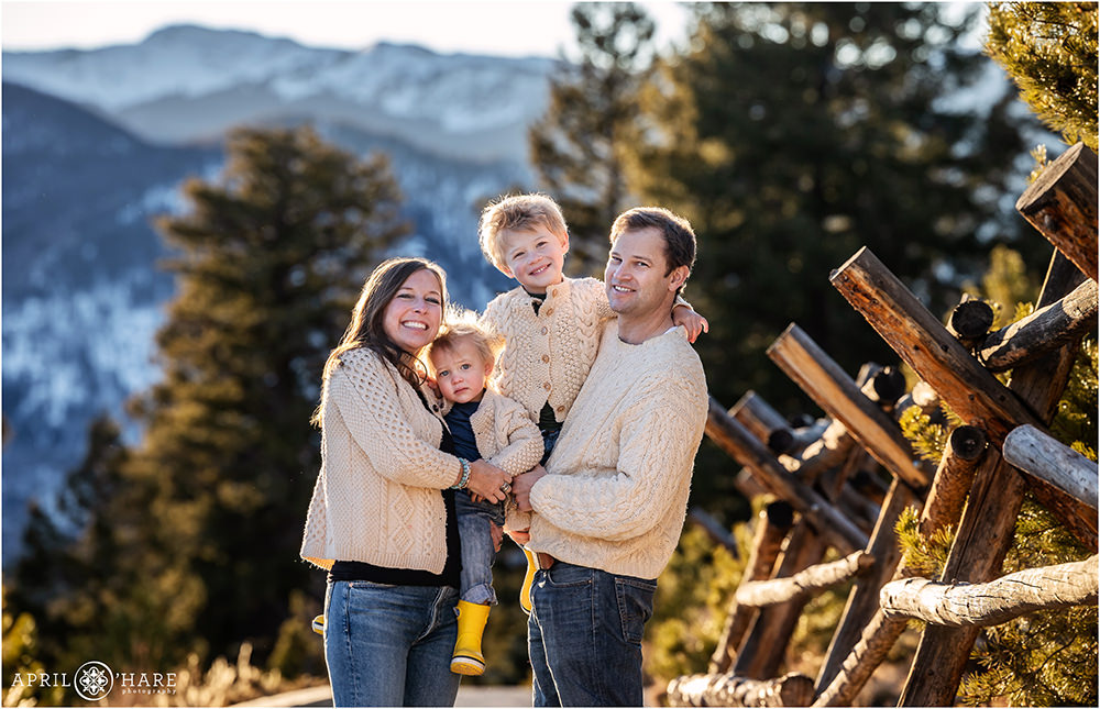 A family of four wearing cream sweater on the path at Sapphire Point in Colorado