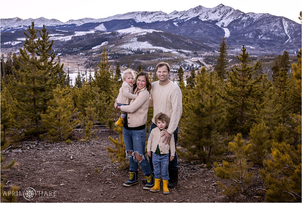 Family of 4 wearing cream sweaters at Sapphire Point in Summit County Colorado