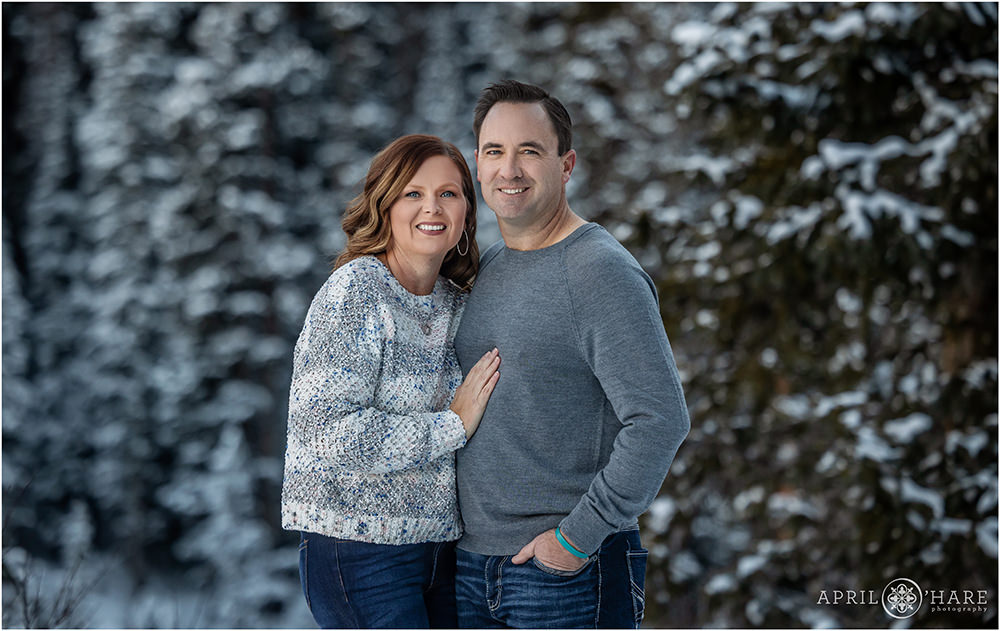 Pretty winter forest family photo for mom and dad alone near Winter Park Colorado