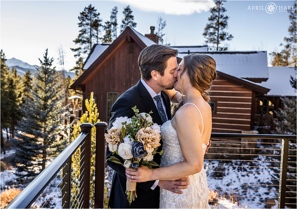 Groom kisses his bride after seeing her at their first look in Keystone Colorado