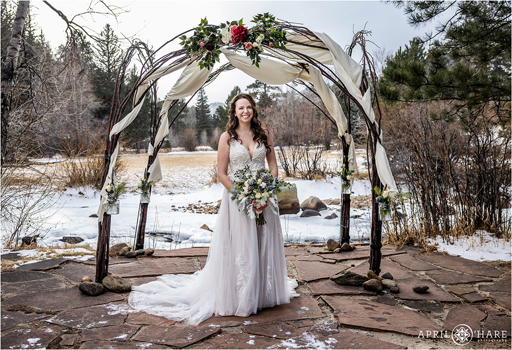 Bridal portrait in front of Tree branch arch at Romantic Riversong Inn in Estes Park Colorado
