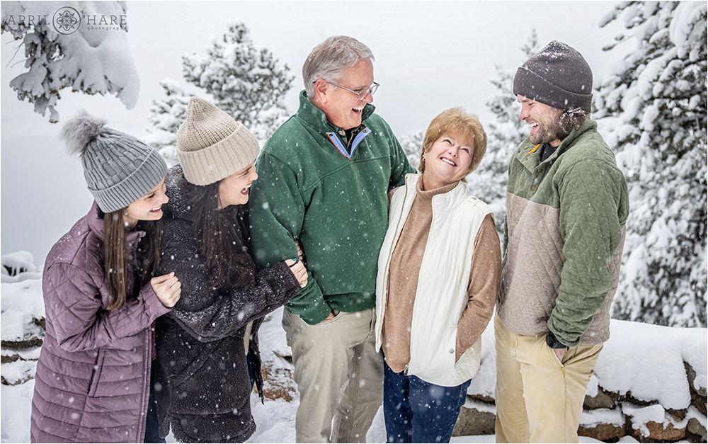 Candid family portrait for a family of 5 with adult children in a snowstorm at Sapphire Point in Colorado