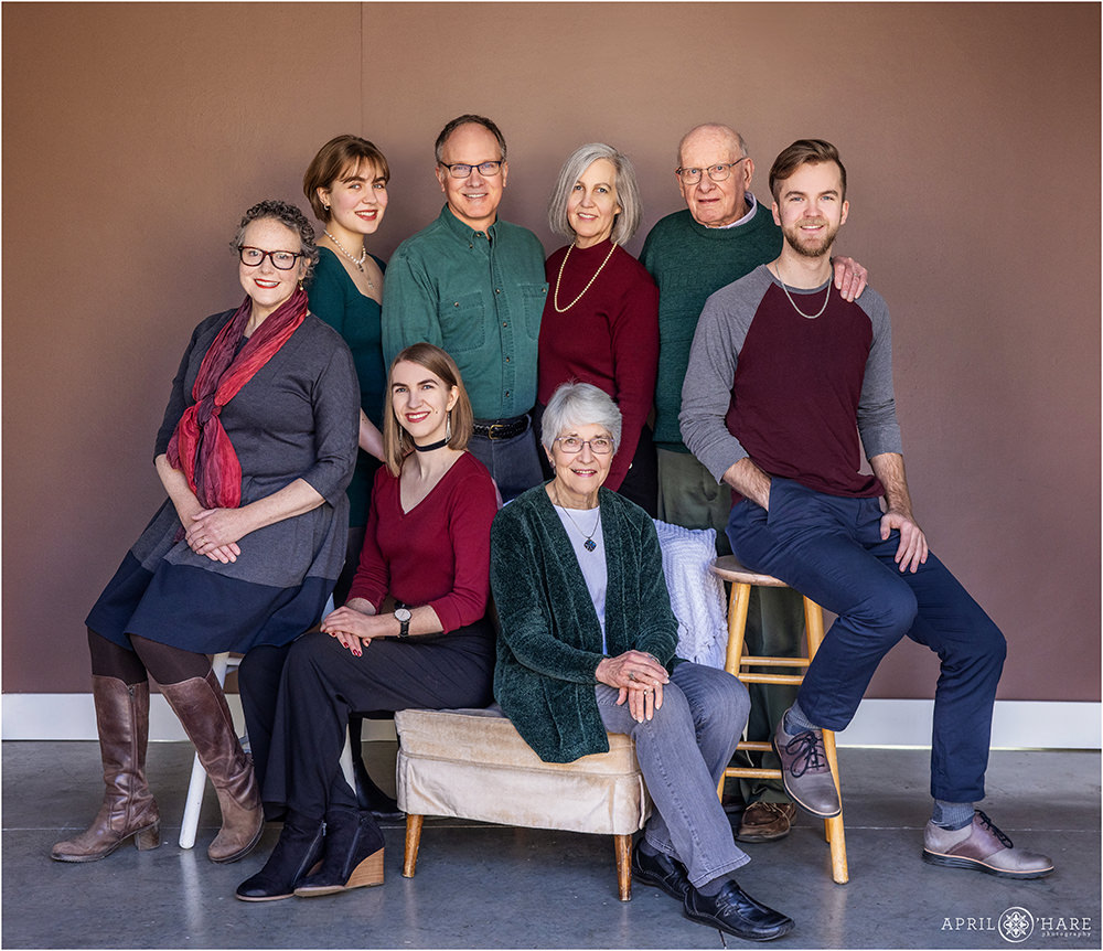 Extended family portrait for a family wearing shades of red and green in Longmont Colorado