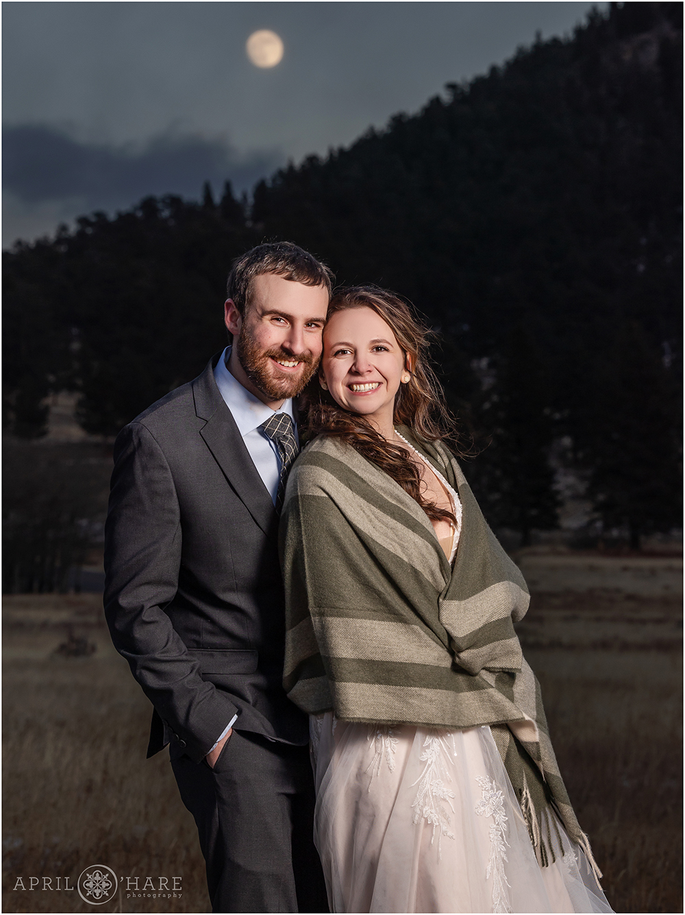 Awesome full moon wedding photo with a chilly couple at their winter wedding inside Rocky Mountain National Park in Colorado