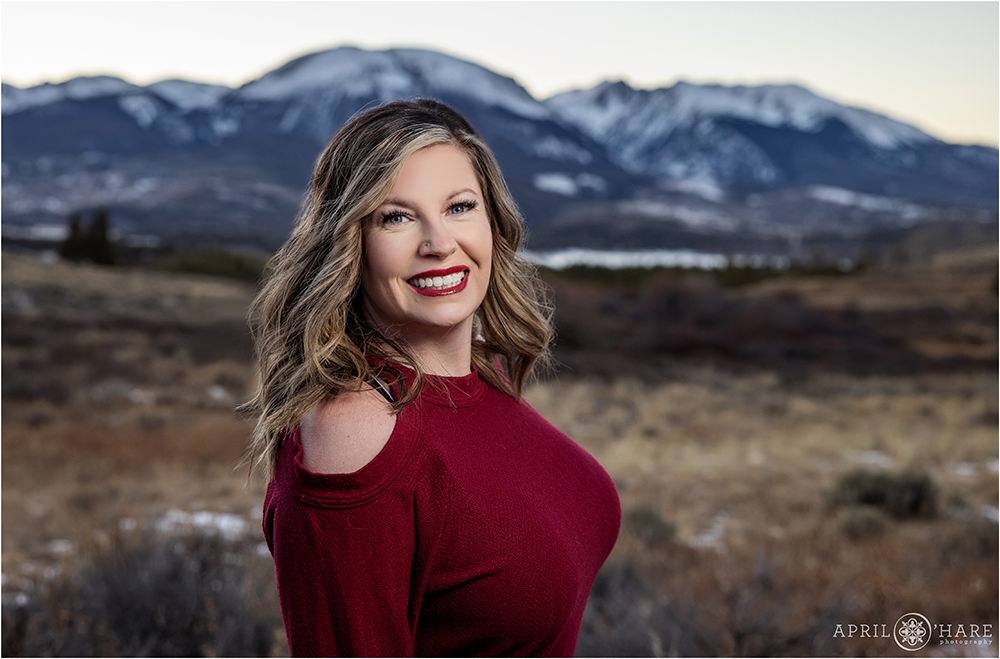 Beautiful headshot portrait of mom by herself with Dillon Reservoir and Buffalo Mountain off in the distance behind her in Dillon Colorado