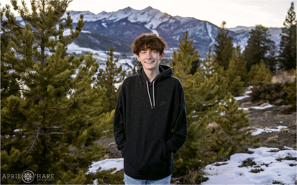 Teenage boy smiles at his family portrait session at Sapphire Point in Colorado