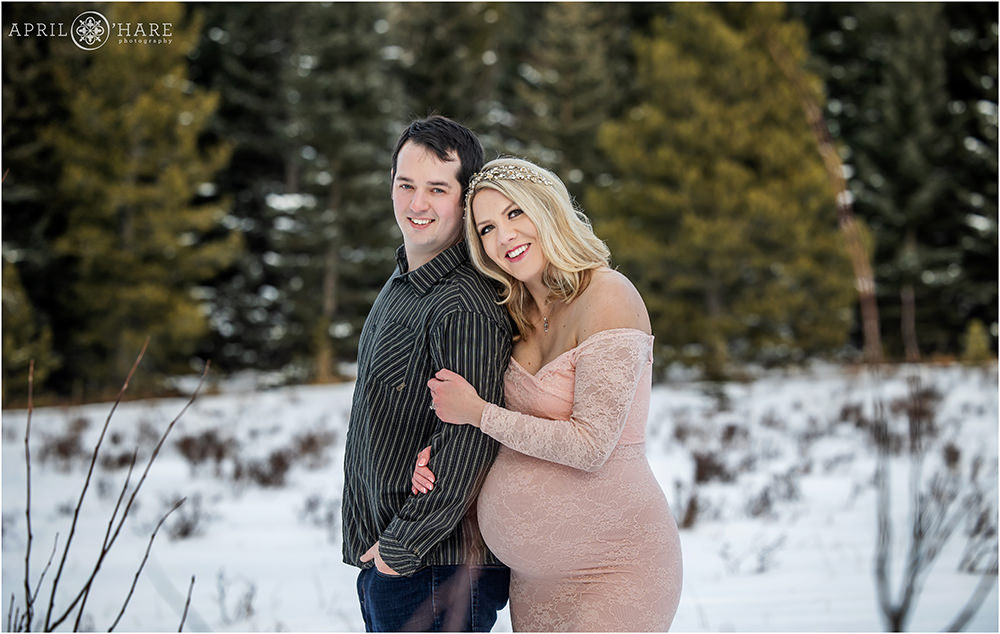 Sweet cuddly winter maternity portrait for an expecting couple in Evergreen Colorado