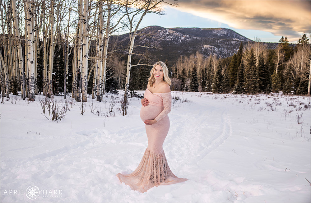 Pretty sunset maternity session in a mountain meadow in Evergreen Colorado