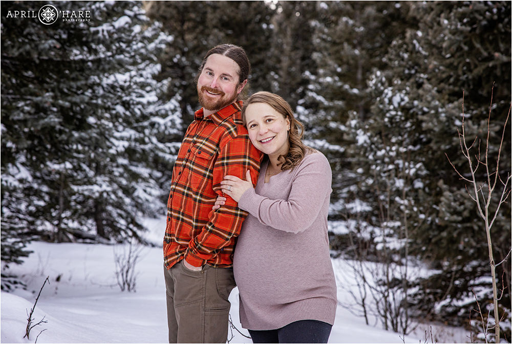 Beautiful Colorado winter forest maternity photography in the middle of a snowy winter wonderland