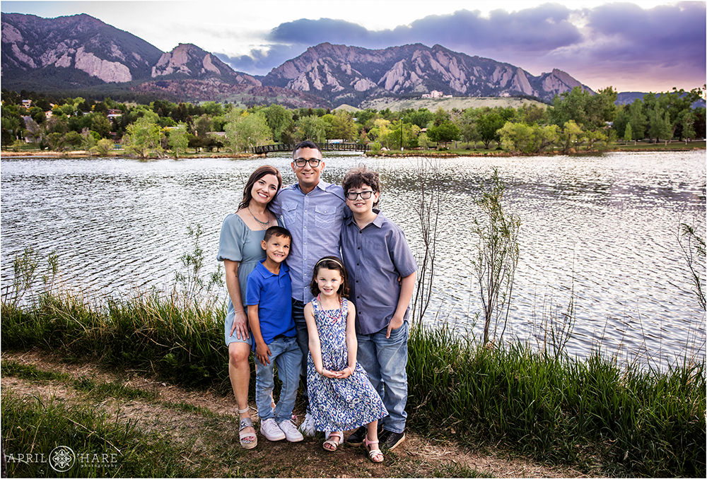 A family of 5 pose in front of Viele Lake at Sunset during Spring in Boulder CO