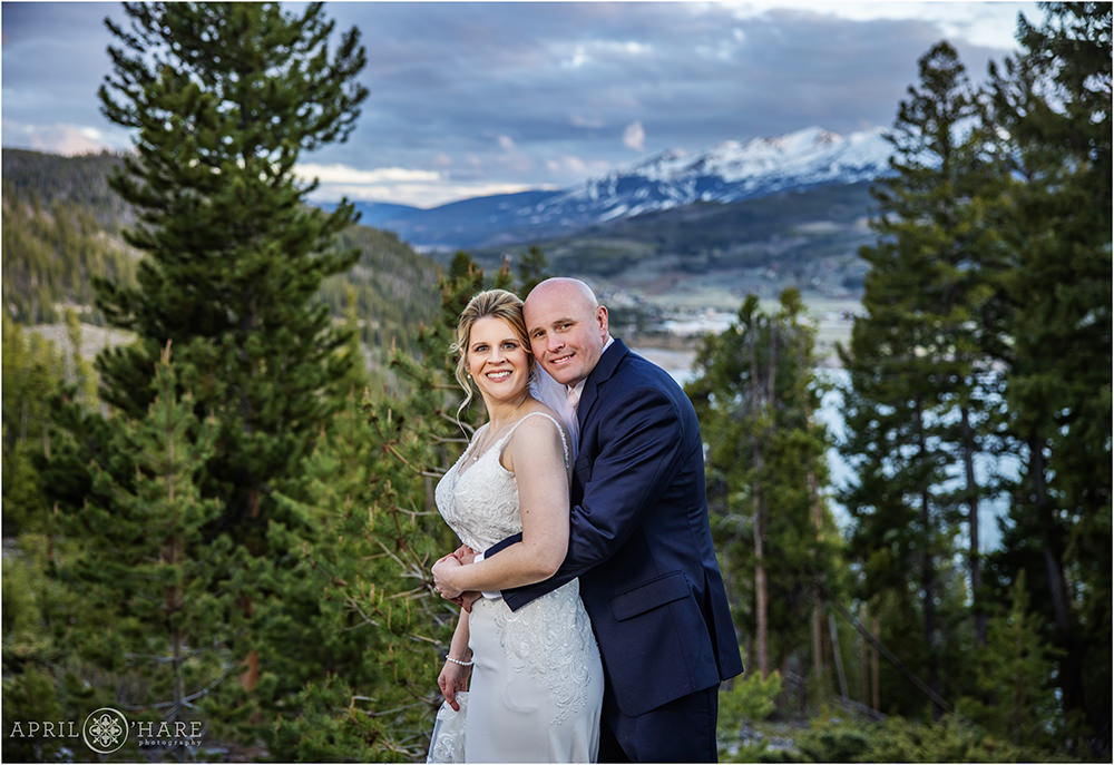Pretty sunset sky Breckenridge Ski Slope backdrop for a bride and groom on their wedding day at Sapphire Point
