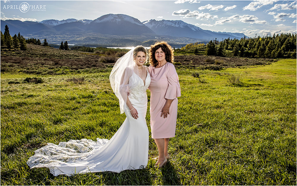 Bride with her mom pose for a portrait on a bright sunny summer day near Lake Dillon in Summit County Colorado