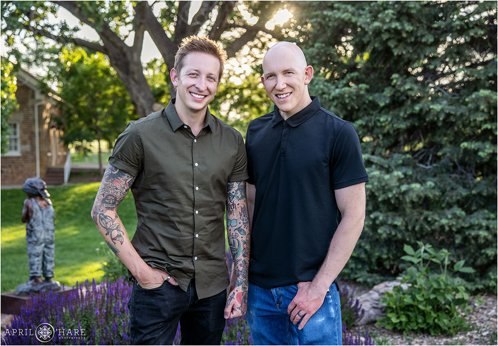 Adult brothers pose for a photo together in the garden next to Stone House in Lakewood Colorado