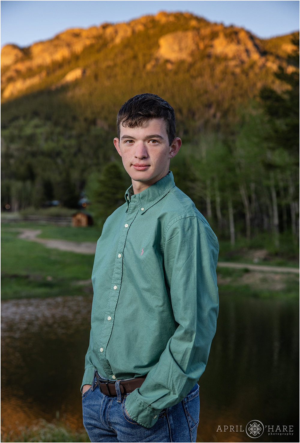 Twin Sisters Peak lit up with pretty red sunset light for a senior portrait at Wind River Ranch in Colorado