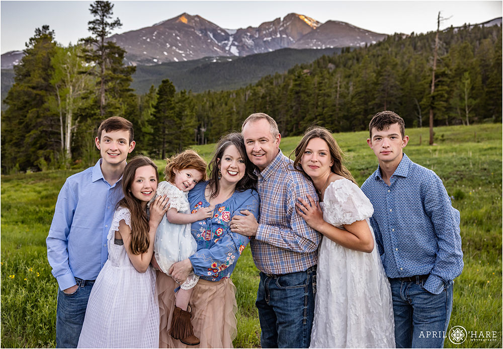 Cute family photo during summer at Wind River Ranch with Longs Peak mountain view