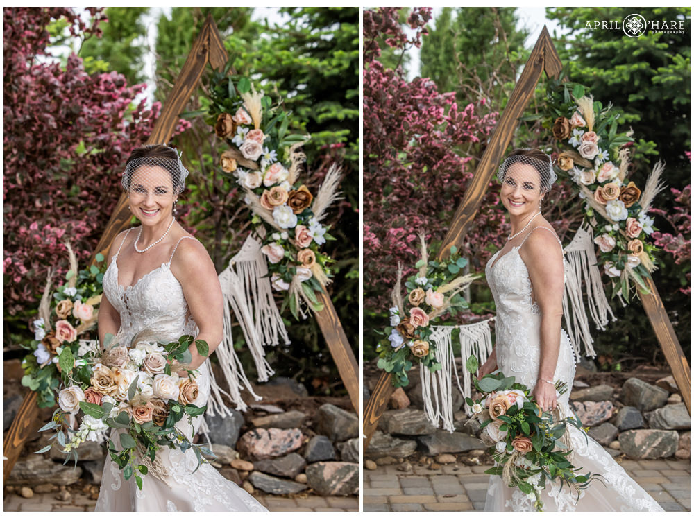 Gorgeous bridal portrait in front of a wood triangle backdrop decoated with boho flowers for a vow renewal party in Colorado