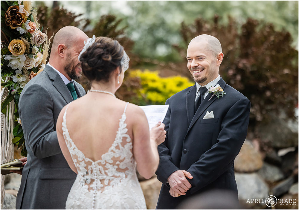 A man smiles at his wife as she renews her vows on their 20th wedding anniversary party in Littleton, CO
