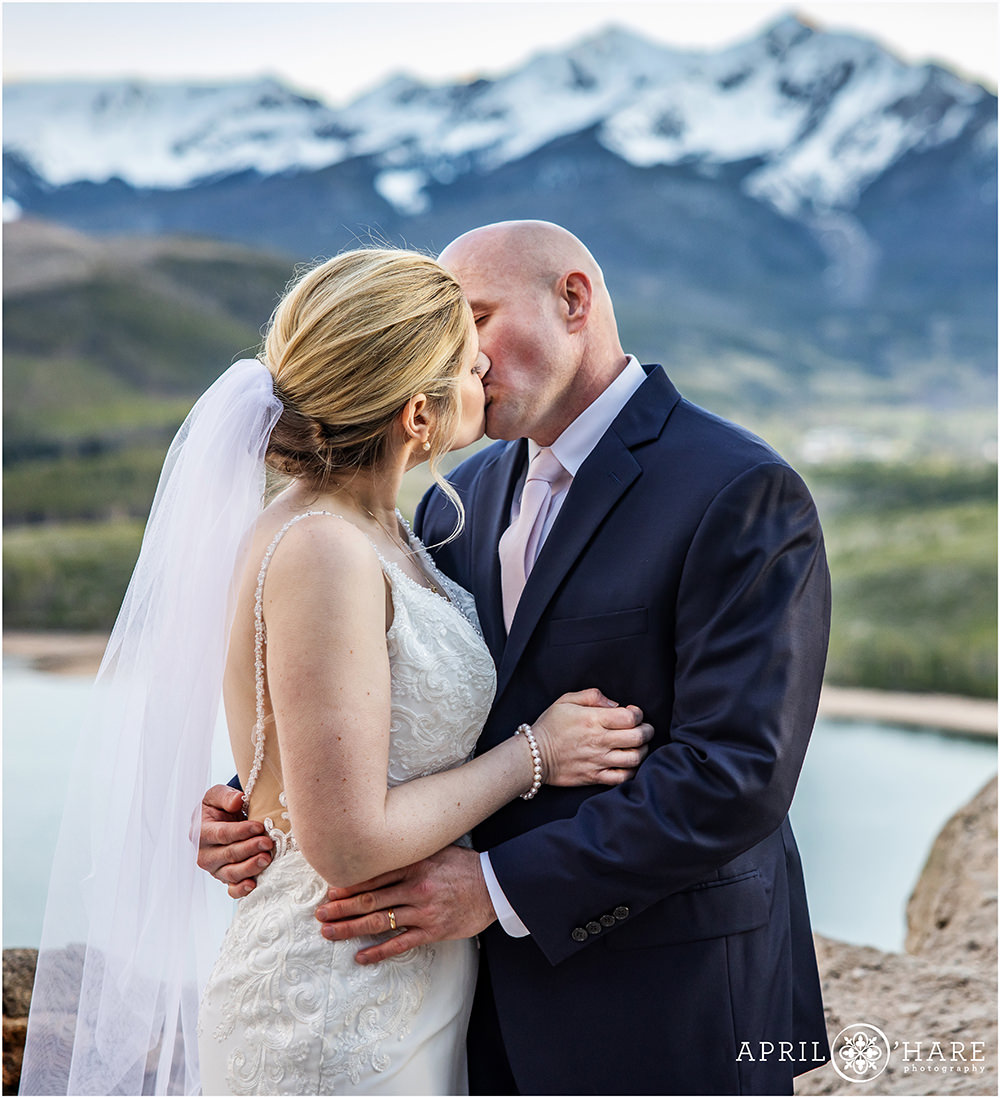 Close up of Ceremony Kiss with mountain backdrop at Sapphire Point in Summit County, Colorado