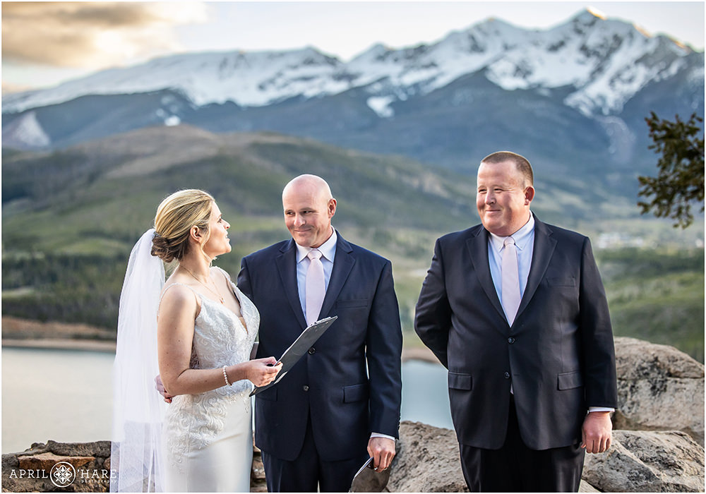 Bride and groom read their vows to each other at sunset at their Sapphire Point Wedding in Colorado