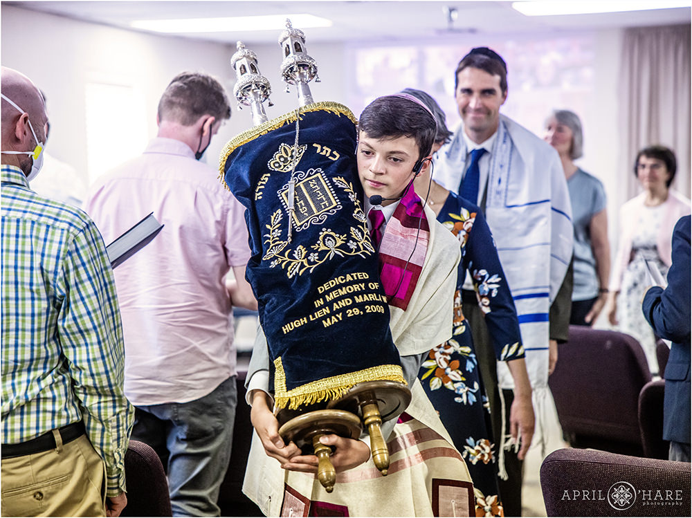 Bar Mitzvah boy carries the torah through the congregation on the day of his bar mitzvah in Lakewood CO
