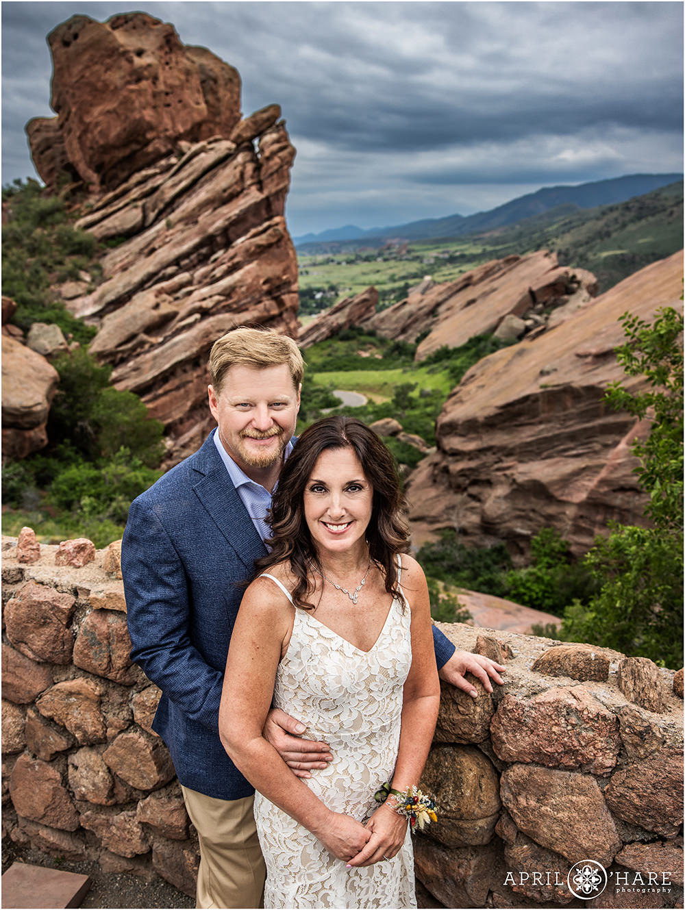 Couple pose for a simple wedding portrait at Red Rocks Trading Post on a stormy summer evening
