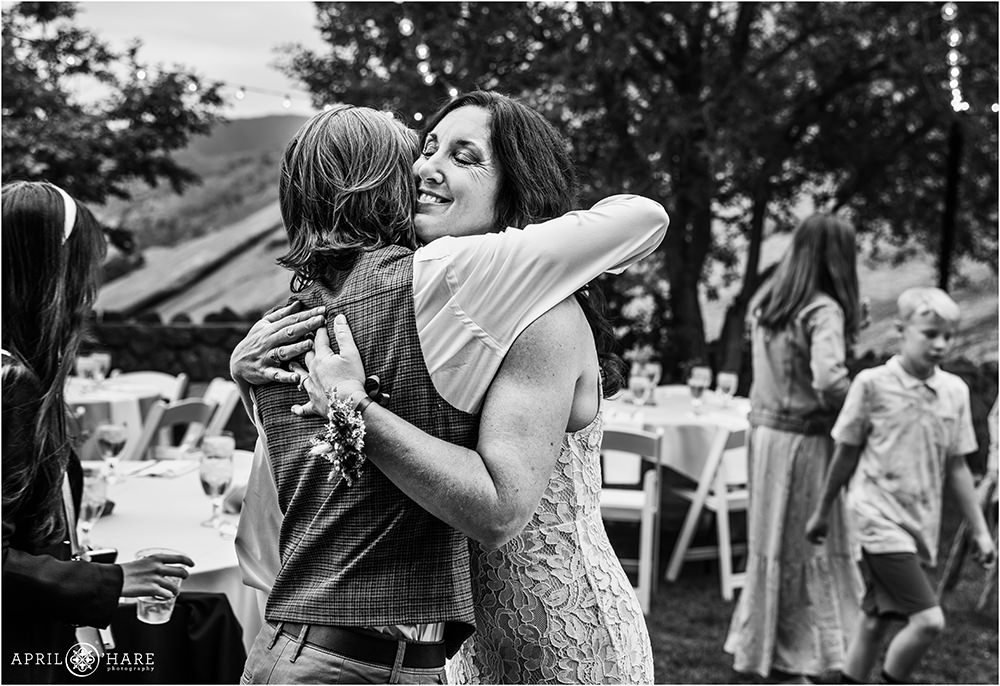 Bride hugs her son on her wedding day at Red Rocks Trading Post Backyard in Colorado