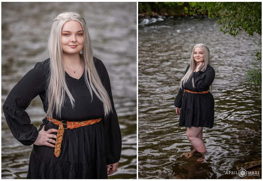 Young adult woman weairng a cute black dress with long sleeves and brown woven belt and silver blonde hair poses while standing in Clear Creek in Golden Colorado