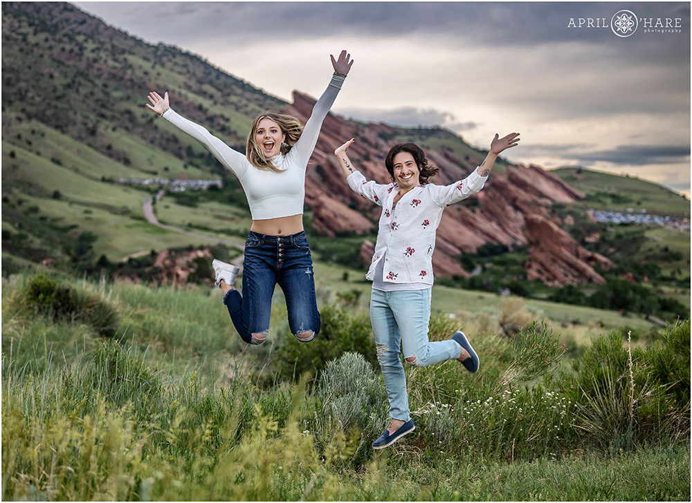 Cousins jump in the air for a fun and silly photo together at East Mount Falcon trailhead in Morrison Colorado