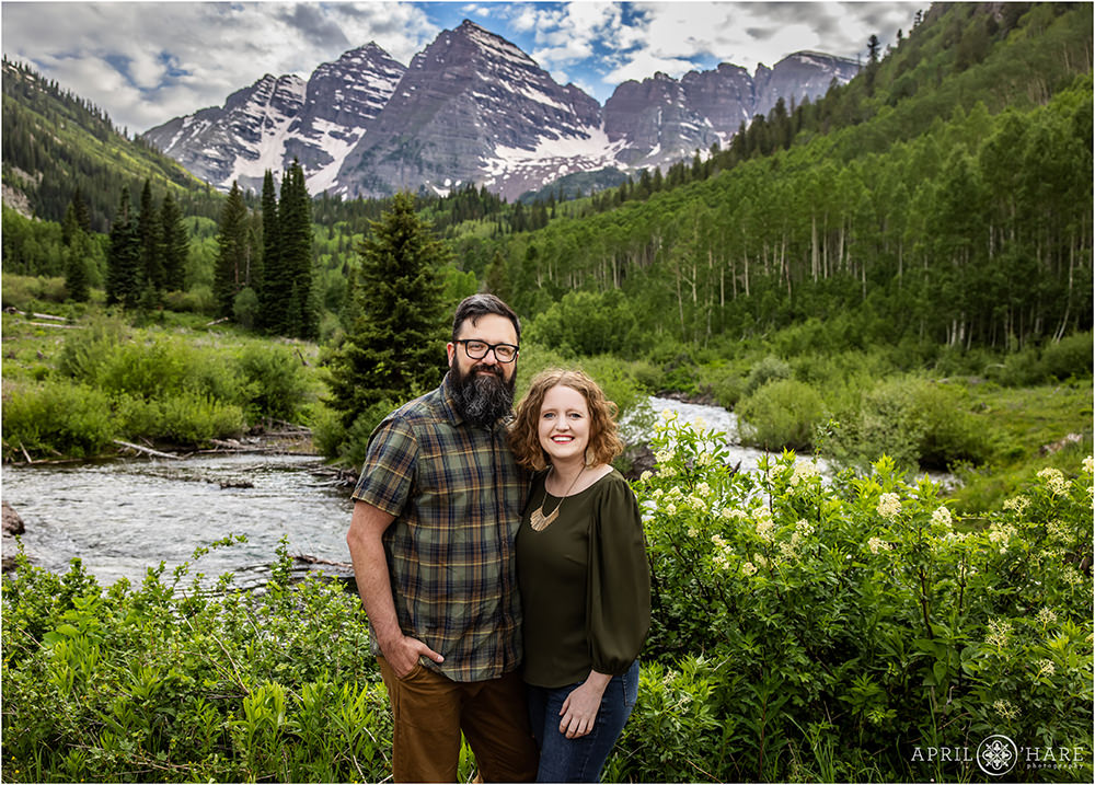 Couples portrait for a married pair wearing green at Maroon Bells in Aspen Colorado