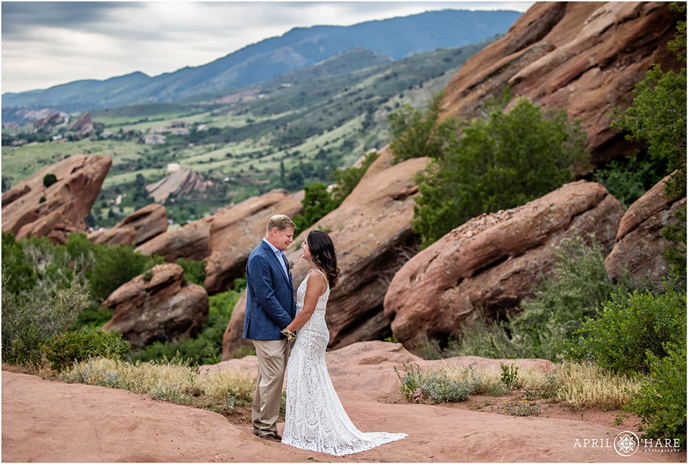 Couple gaze lovingly into each other's eyes in the beautiful surrounding of Red Rocks in Colorado