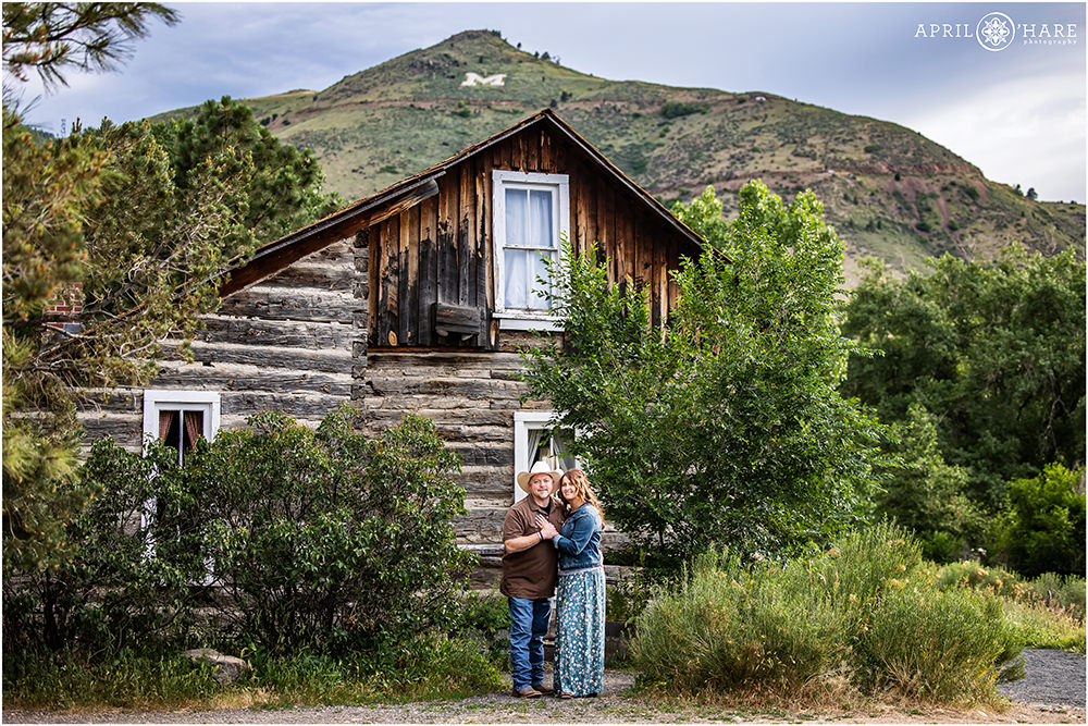 Beautiful couples portrait in front of an old wood cabin at the Clear Creek History Park in Golden Colorado