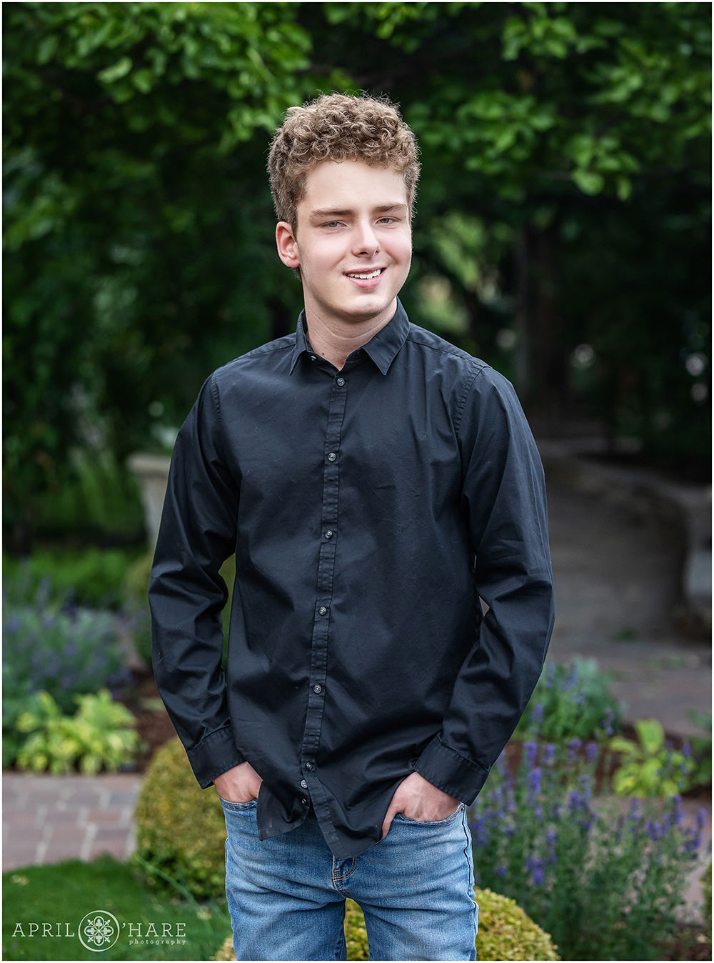 High school senior boy wearing a black button down shirt at Denver Botanic Gardens in Colorado