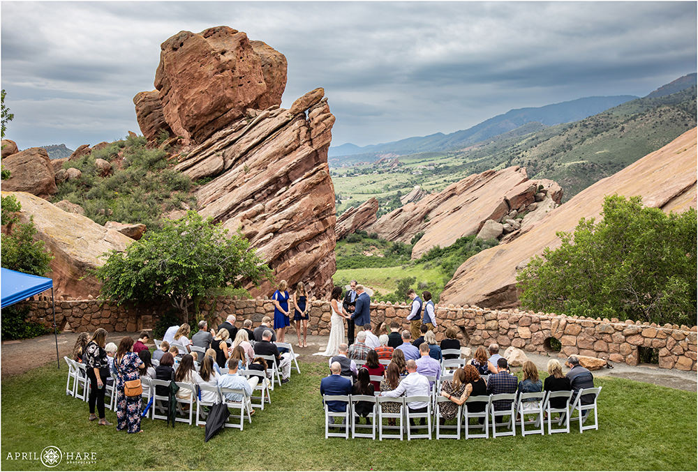 Small wedding in the backyard of the Red Rocks Trading Post on a stormy summer evening in Colorado