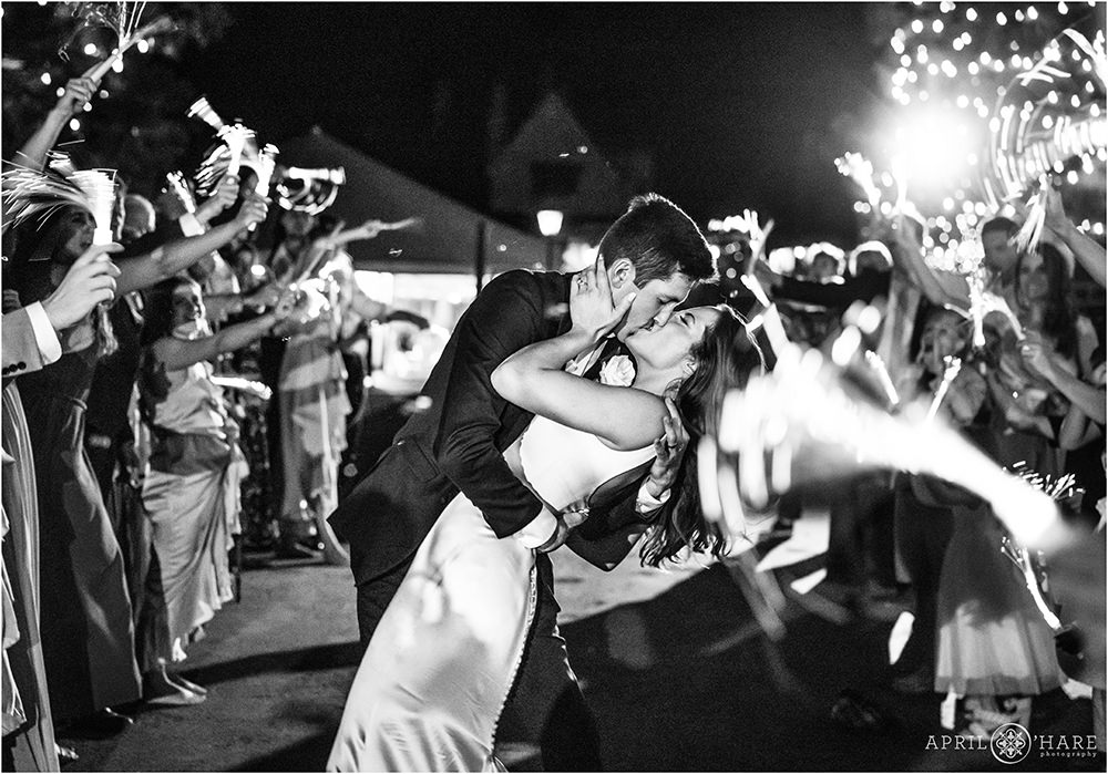 Wedding couple dip kiss at their grand exit at a Castle Wedding in Colorado