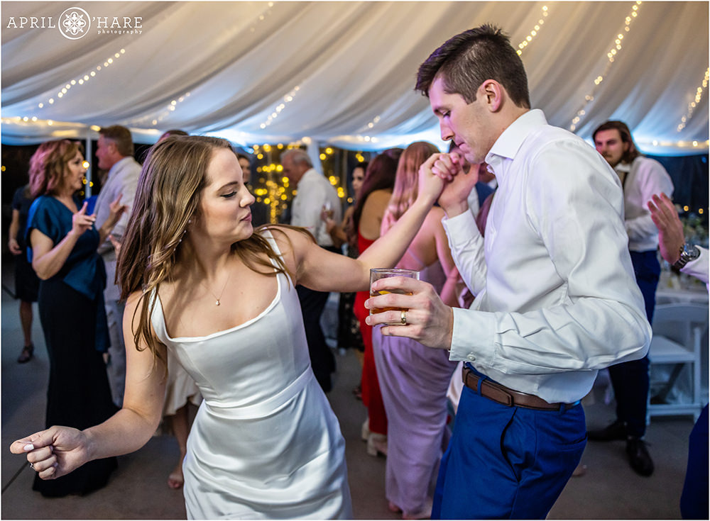 Bride and groom dance together at their wedding reception at Cherokee Ranch and Castle in Colorado