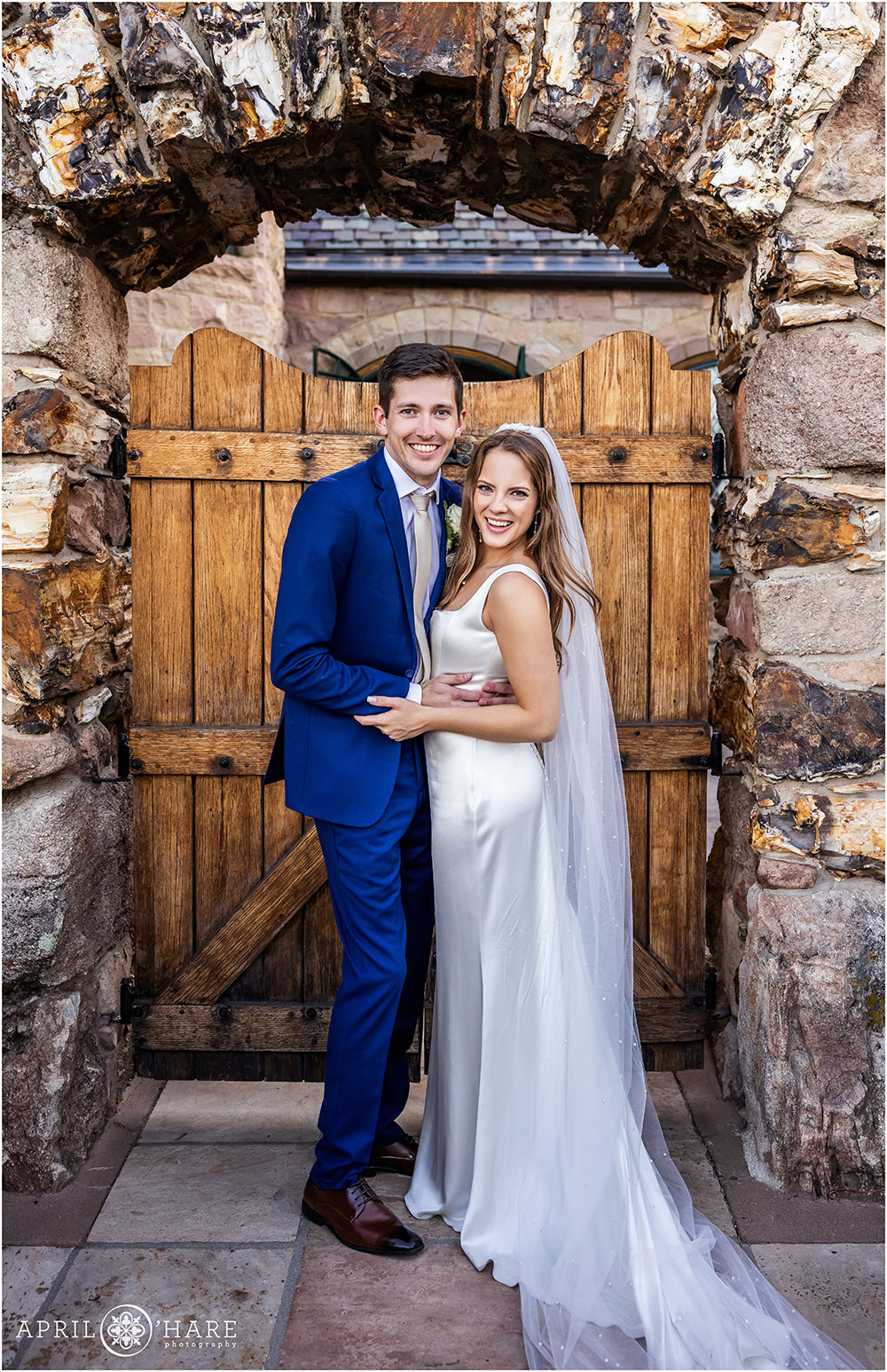 Adorable wedding couple poses in the archway at Cherokee Ranch and Castle